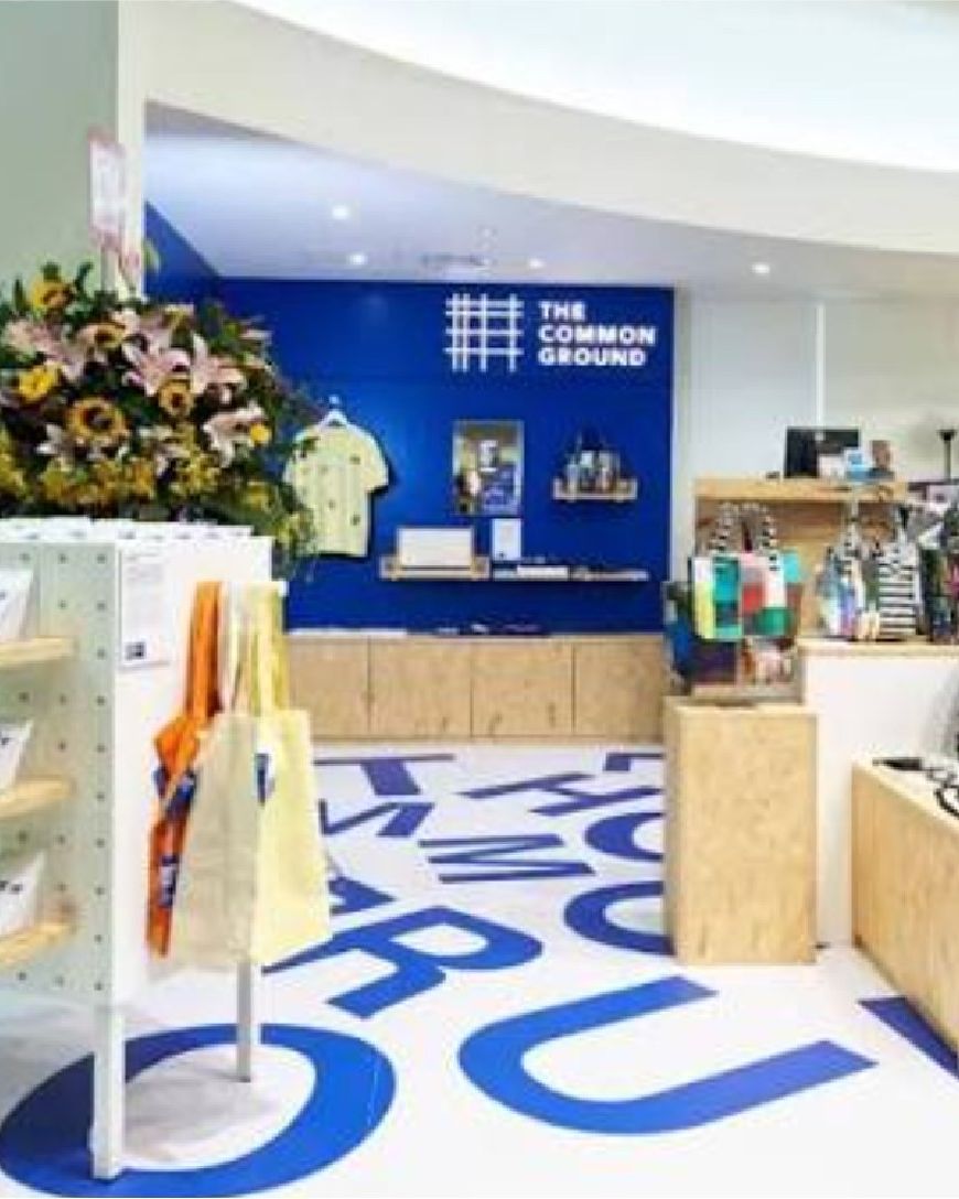 The Common Ground mall pop-up with giant blue floor lettering