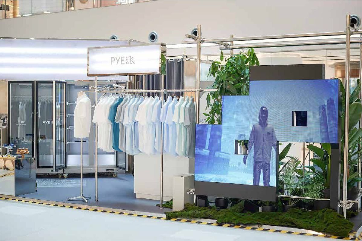 PYE x Three-Body mall pop-up: steel-pipe frame, LED screens, moss bed and shirt rails